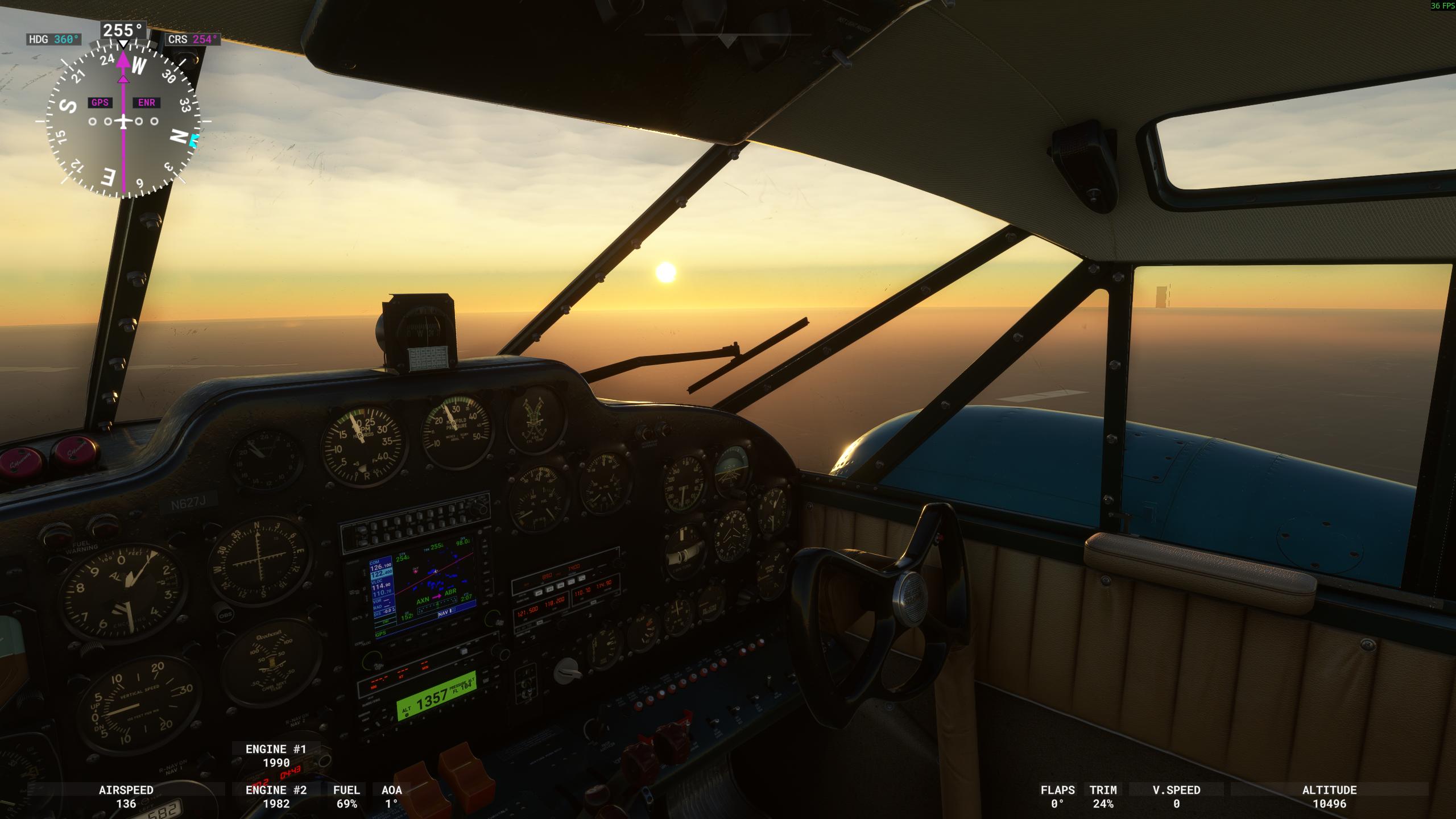 Screenshot of Microsoft Flight Simulator 2020. Cockpit of vintage aircraft in flight, with early sunset and lakes in background.