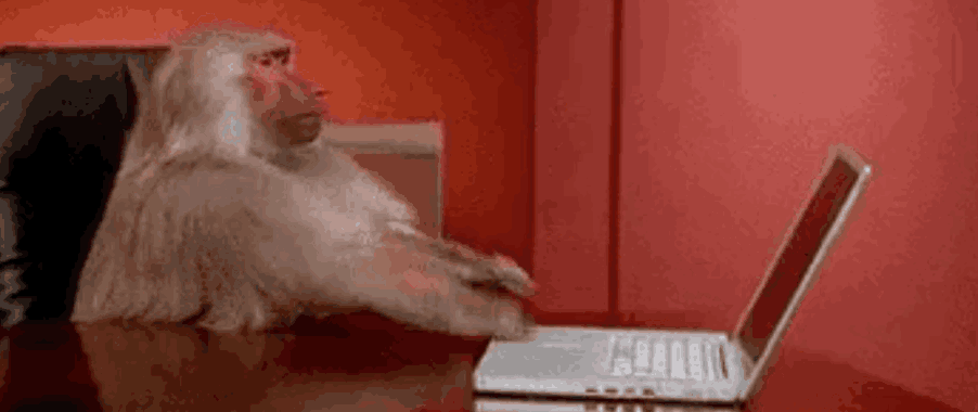 gif of a baboon shoving a laptop off a desk