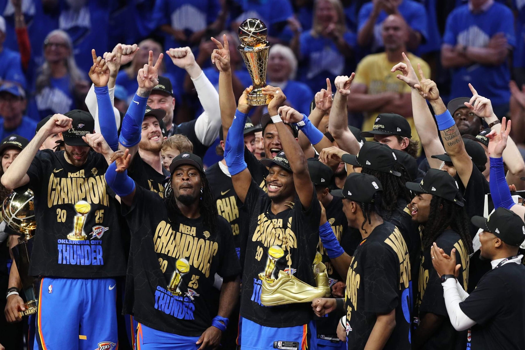 Photo of Oklahoma City Thunder players on stage, celebrating winning the 2025 NBA Championship