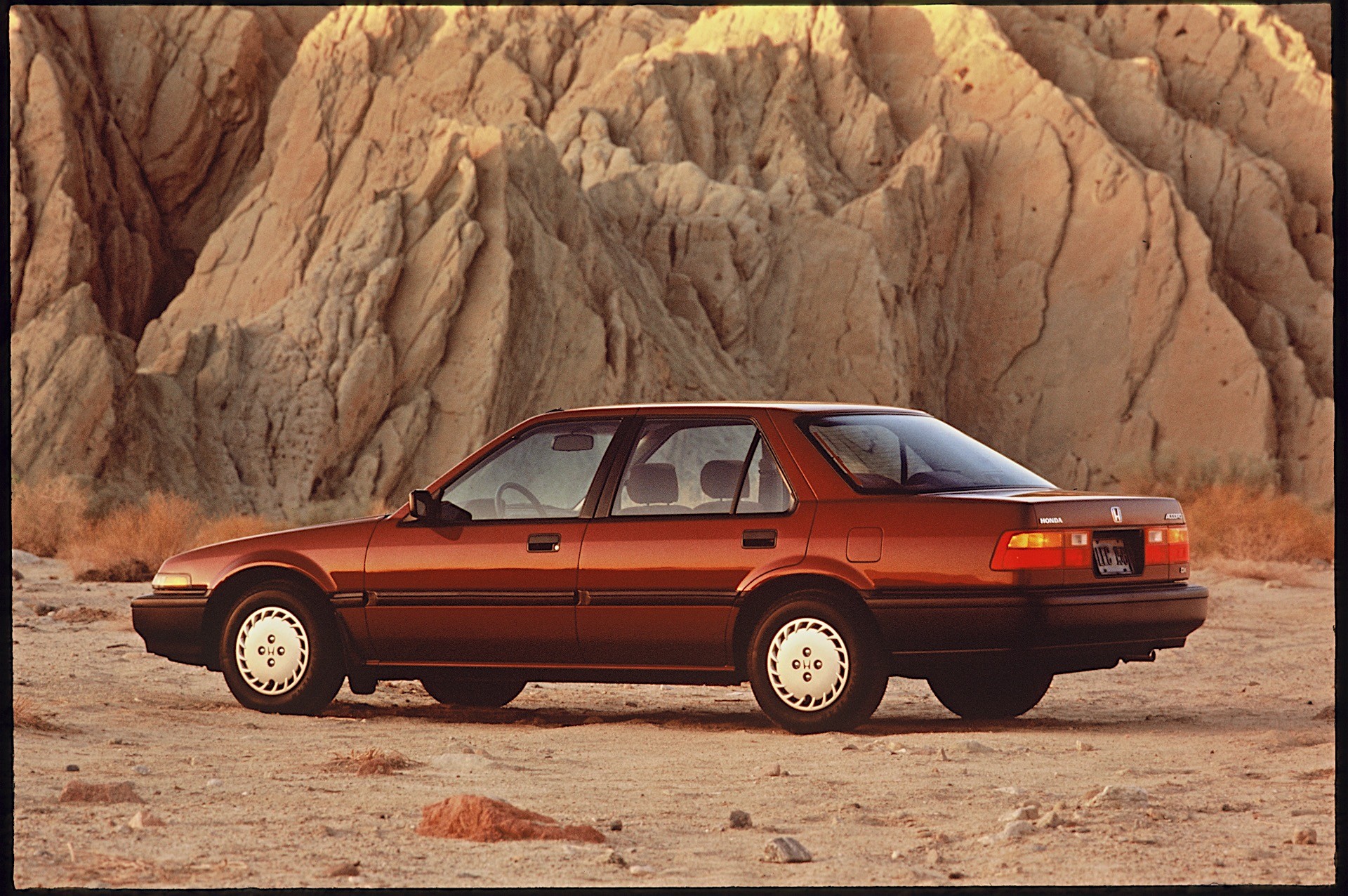 photo of a 1980s honda accord in a desert background