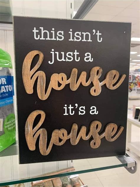 photo of a tacky sign, with the text this isn't just a house, it's a house written on it. A misprint of the saying it's not just a house, it's a home.